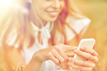 Image showing close up of woman with smartphone and earphones