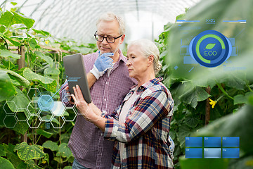 Image showing senior couple with tablet pc at farm greenhouse