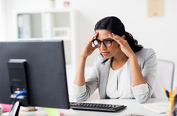 Image showing stressed businesswoman with computer at office