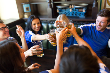 Image showing football fans clinking beer glasses at sport bar