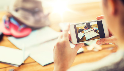 Image showing close up of woman with smartphone and travel stuff