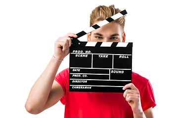 Image showing Young man holding a clapboard