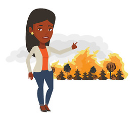 Image showing Woman standing on background of wildfire.