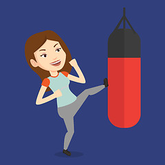 Image showing Woman exercising with punching bag.