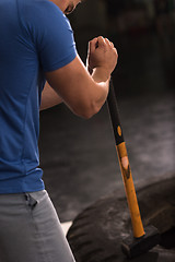 Image showing man workout with hammer and tractor tire