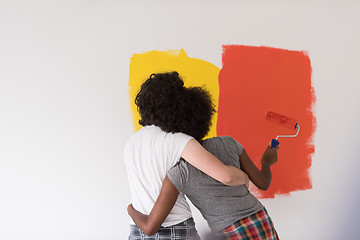 Image showing multiethnic couple painting interior wall