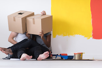 Image showing young multiethnic couple playing with cardboard boxes