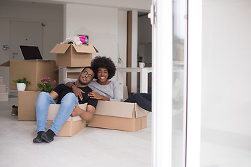 Image showing African American couple  playing with packing material