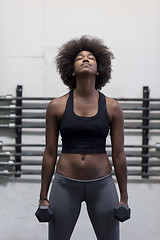 Image showing black woman doing bicep curls