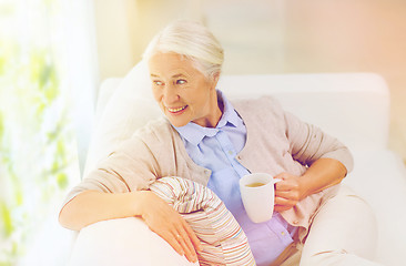 Image showing happy senior woman with cup of tea at home