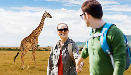 Image showing smiling couple with backpacks traveling in africa