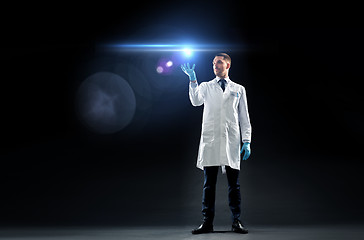 Image showing doctor or scientist in lab coat with laser light