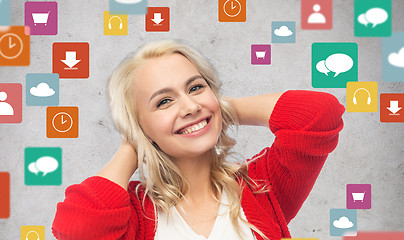 Image showing happy smiling young woman in red cardigan