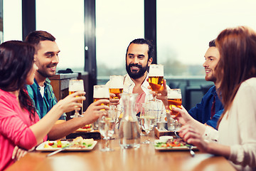 Image showing friends dining and drinking beer at restaurant