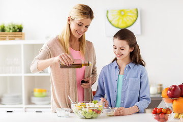 Image showing happy family cooking salad at home kitchen