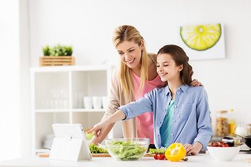 Image showing family cooking dinner using tablet pc at kitchen