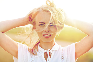 Image showing close up of happy young woman in white outdoors