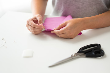 Image showing woman with needle stitching fabric pieces