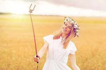 Image showing happy young woman taking selfie by smartphone