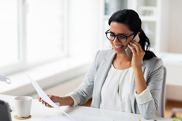 Image showing businesswoman calling on smartphone at office