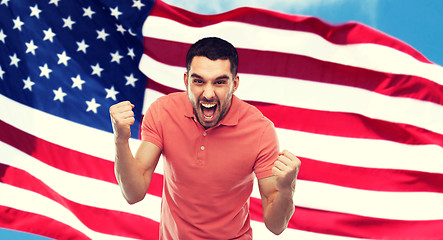 Image showing angry man showing fists over american flag