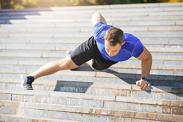 Image showing Fit man doing exercises outdoors at park