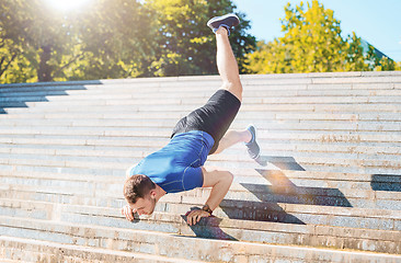 Image showing Fit man doing exercises outdoors at park