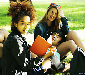 Image showing cute group of teenages at the building of university with books huggings