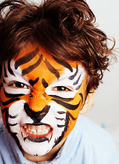 Image showing little cute boy with faceart on birthday party close up, little cute tiger