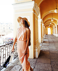 Image showing young pretty smiling woman in hat with bags on shopping at store