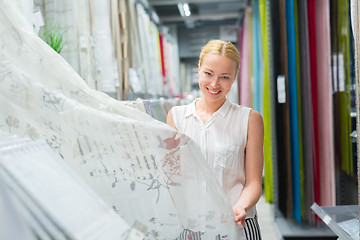 Image showing Woman choosing the right item for her apartment in a modern home furnishings store.