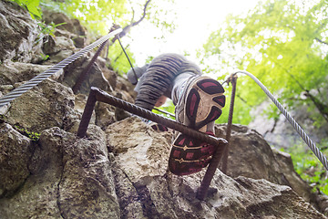 Image showing Woman climbing on the rocky route up the mountain.