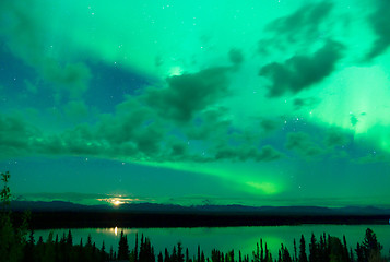 Image showing The Aurora Borealis emerges through clouds remote Alaska