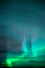 Image showing The Aurora Borealis emerges through clouds remote Alaska