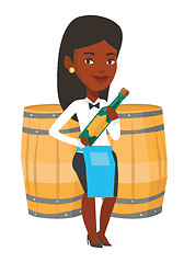 Image showing Waitress holding bottle of alcohol.