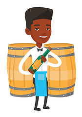 Image showing Waiter holding bottle of alcohol.