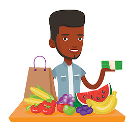 Image showing Young man standing at the table with shopping bag