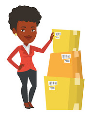 Image showing Business woman checking boxes in warehouse.