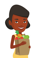 Image showing Happy woman holding grocery shopping bag.