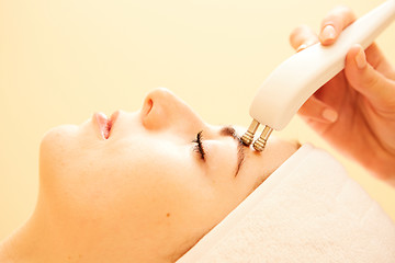 Image showing Cosmetology. Beautiful Woman At Spa Clinic Receiving Stimulating Electric Facial Treatment From Therapist. Closeup Of Young Female Face During Microcurrent Therapy. Beauty Treatment.