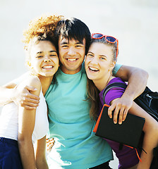 Image showing cute group of teenages at the building of university with books huggings