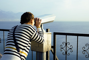 Image showing young woman looking through telescope at sea viewpoint in Ataturk park