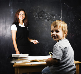 Image showing little cute boy with teacher in classroom