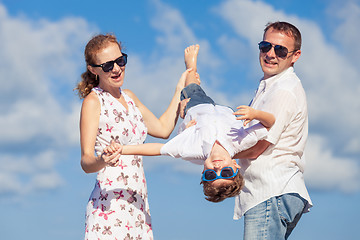 Image showing Happy family walking on the beach at the day time.