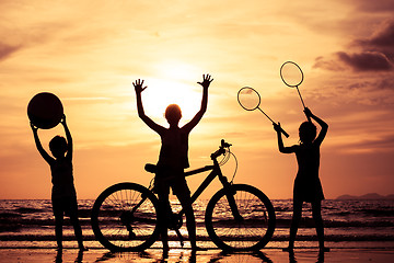 Image showing Happy children playing on the beach at the sunset time.