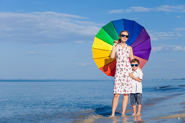 Image showing Mother and son playing on the beach at the day time.