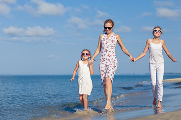 Image showing Mother and children playing on the beach at the day time.