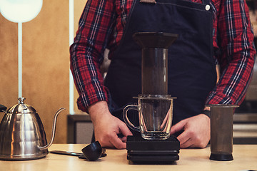 Image showing Barista brewing aeropress coffee