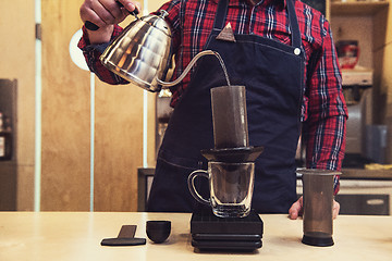 Image showing Barista brewing aeropress coffee