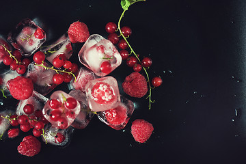 Image showing Frozen berries on wooden table